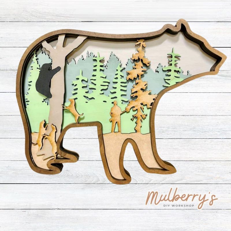 Our multilayered projects are so much fun to paint. This 6-layered project features a bear in a tree with a hunter and dogs in the woods. It's approximately 9 inches tall by 11 inches wide.