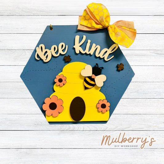 Our bee kind honeycomb mini door hanger is honey-tastic! Approximately 10.5" tall by 12.5" wide.