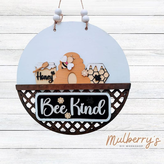 Welcome family and friends with our interchangeable lattice round door hanger! Simply swap out inserts to match the different holidays and seasons! It's approximately 10.5" in diameter.  Includes: Lattice Round Door Hanger with Bee Inserts. Additional inserts are available to purchase.