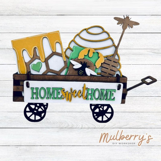 It doesn't get any cuter than our little rustic wagon! It's a perfect add on accessory to your décor. It's approximately 4" tall x 12" wide.  Includes: Wagon and Bee Inserts.  Bee inserts include honey comb, jar of honey with bee, hive, honey stirrer, and the Home Sweet Hive banner.