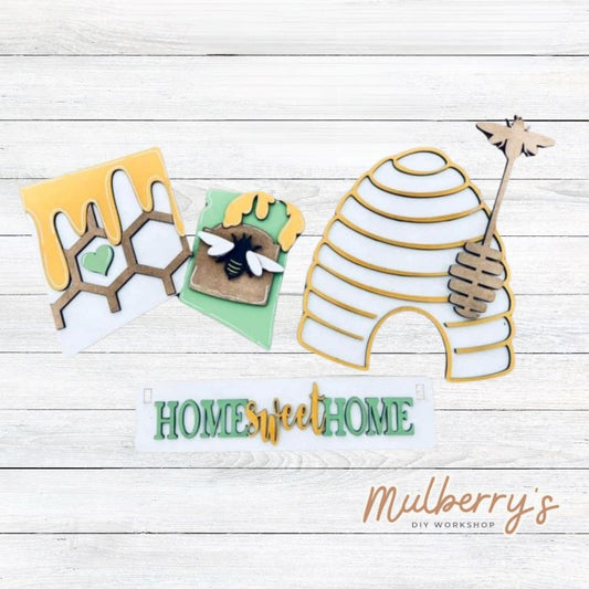 Our bee inserts are so versatile! Display them individually or in our interchangeable wagon or crate! Includes honey comb, jar of honey with bee, hive, honey stirrer, and the Home Sweet Hive banner.