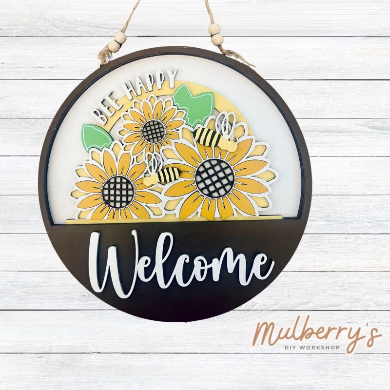 Welcome family and friends with our interchangeable welcome door hanger! Simply swap out inserts to match the different holidays and seasons! It's approximately 10.5" in diameter.  Includes: Welcome Door Hanger with Bee Insert. Additional inserts are available to purchase.