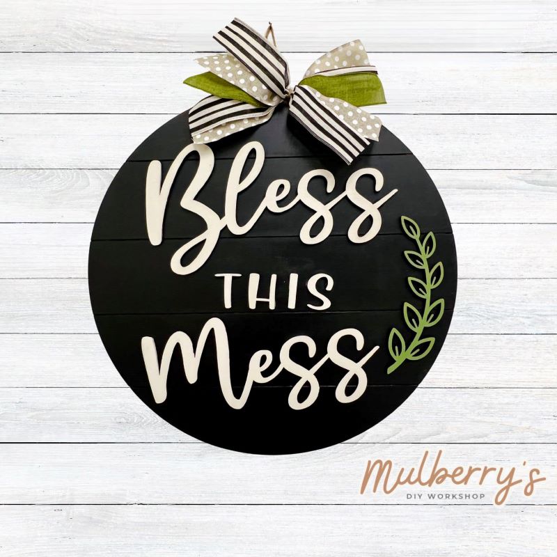 Decorate your front door with our 18" Bless This Mess door hanger!