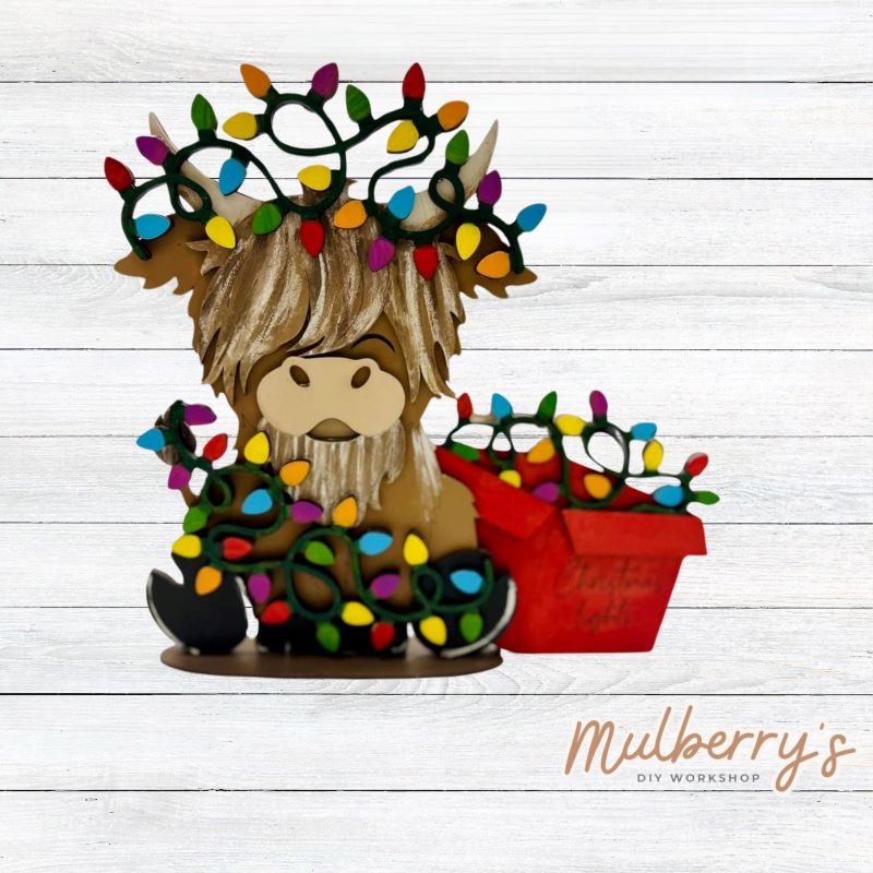 Celebrate the holiday season with our newest Christmas highland cow! He's decorated with lights and would make a great addition to your holiday decor! Approximately 9" tall. NOT interchangeable like the other highland cows.