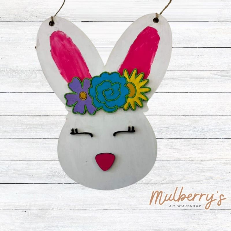 Come to the workshop and paint our adorable floral Easter bunny mini door hanger! Approximately 12" tall by 10" wide.