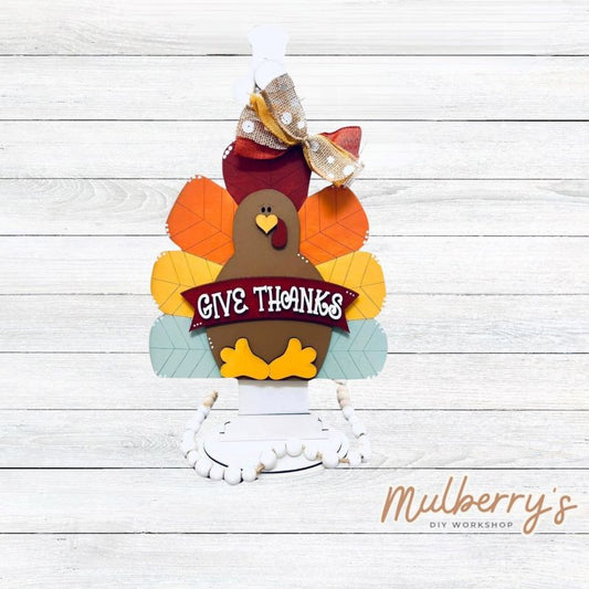 Our give thanks turkey mini door hanger is too cute! Approximately 10" tall by 10" wide.