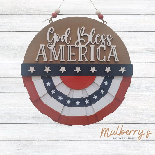 Celebrate 4th of July with our God Bless America Patriotic mini door hanger! Approximately 10.5" in diameter.