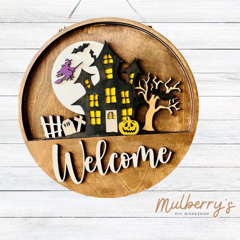 Welcome family and friends with our interchangeable welcome door hanger! Simply swap out inserts to match the different holidays and seasons! It's approximately 10.5" in diameter.  Includes: Welcome Door Hanger with Haunted House Insert. Additional inserts are available to purchase.