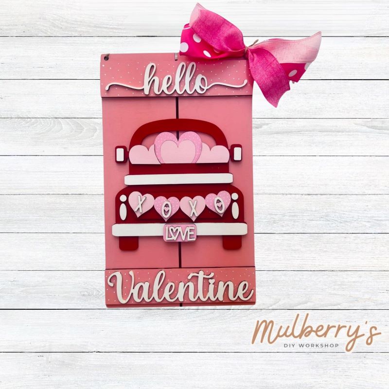 Decorate your front door for Valentine's Day with our Hello Valentine Truck mini door hanger! Approximately 12" tall by 8" wide.