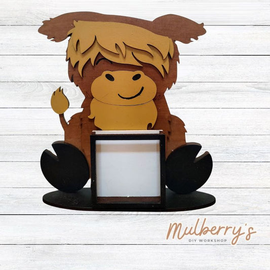 We love our interchangeable highland cow! It's approximately 9" tall and can be paired with your favorite seasonal/holiday insert.