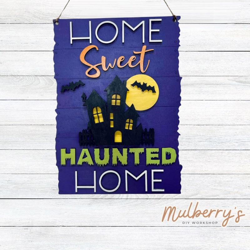Our home sweet haunted home mini door hanger is perfect for Halloween! Approximately 12" tall.