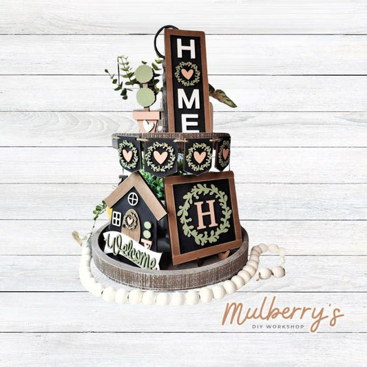 Looking for a tiered tray set to keep up all year long! We have you covered with our 6-piece Home Tiered Tray set. The rectangular piece with wreath can be personalized with your last name initial. Pieces can be purchased separately too.