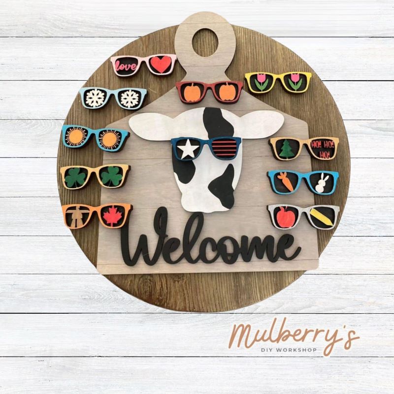 Our sweet cow on cutting board is super cool all year long! Change out his sunglasses to match the season or holiday. There are 11 pairs of sunglasses. The cutting board measures 12" tall. Optional stand is available.