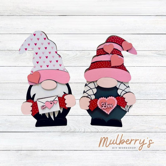 Our interchangeable mini gnomes are approximately 9" tall. They are 3 layers; therefore, they will stand freely. There are two choices. Hats and Hands are interchangeable and can be switched out for every holiday/season. Scrapbook paper embellishment is NOT included.  Includes interchangeable gnomes and valentine inserts.