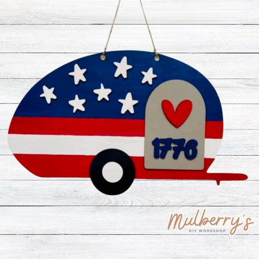 Our 1776 patriotic camper door hanger is too cute! Approximately 16" wide by 11" tall.