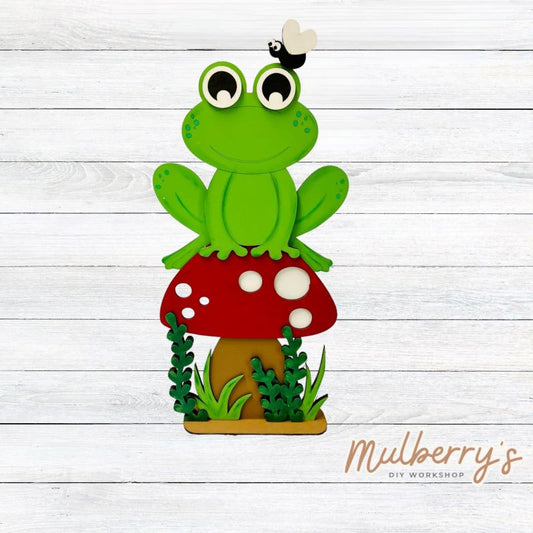 Our large frog on mushroom shelf sitter is frog-tastic! Approximately 15" tall by 6" wide.