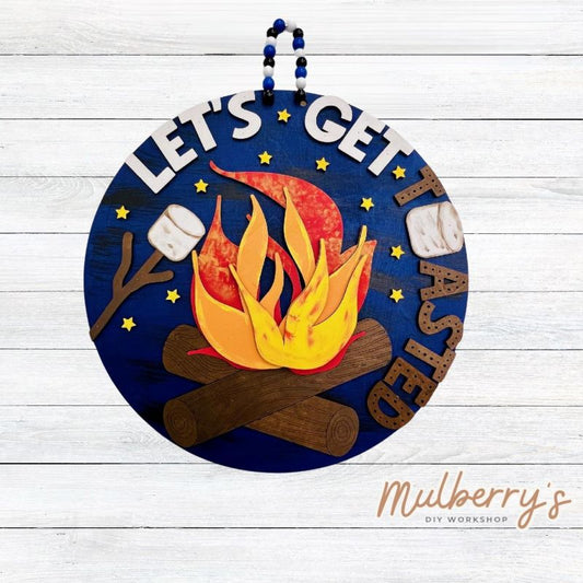 Let's get toasted! Our newest camping door hanger would look fabolous hanging in your cabin or camper! Approximately 18" in diameter.