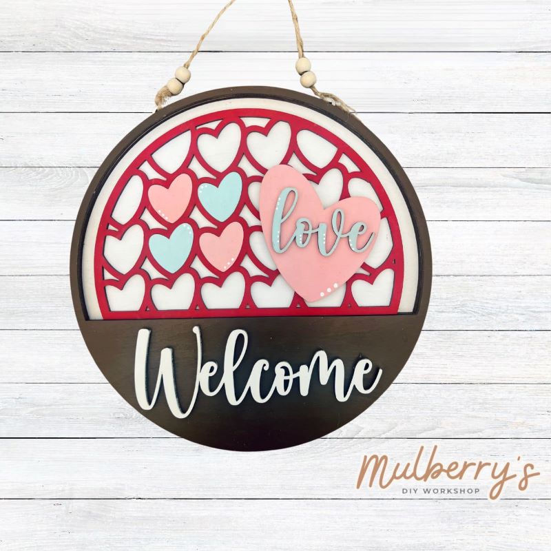 Welcome family and friends with our interchangeable welcome door hanger! Simply swap out inserts to match the different holidays and seasons! It's approximately 10.5" in diameter.  Includes: Welcome Door Hanger with Love Insert. Additional inserts are available to purchase.