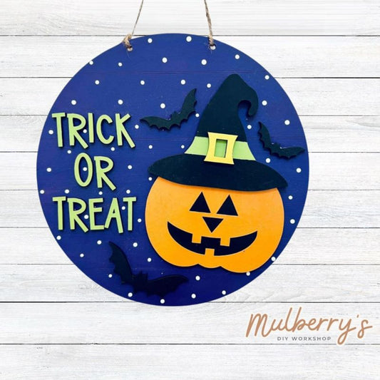 Our trick or treat mini door hanger is perfect for Halloween! Approximately 10.5" in diameter.