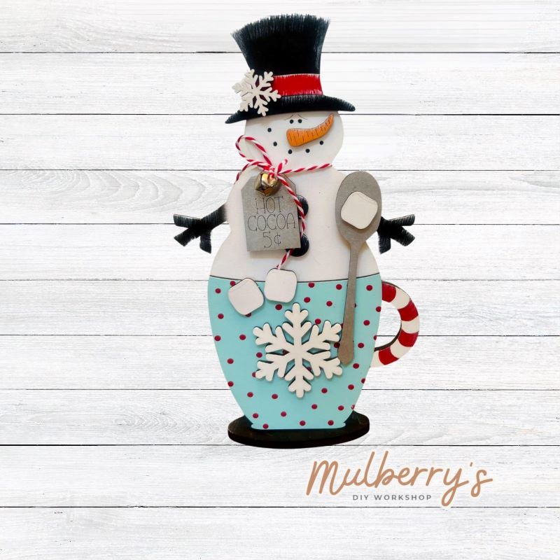 This adorable snowman in a mug is the perfect addition to your winter decor! He's approximately 9.5" tall by 5.5" wide.