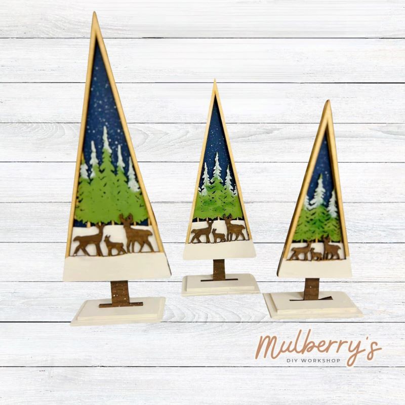 Our trees are three-layered thick with trees and deer and each comes with a stand. The tallest tree is roughly 10.5 inches tall, the middle tree is roughly 9 inches tall, and the smallest tree is roughly 7.5 inches tall. Trees may be purchased solo or as a set.