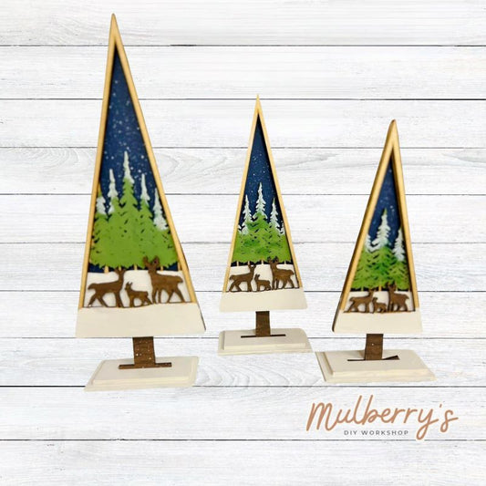 Our trees are three-layered thick with trees and deer and each comes with a stand. The tallest tree is roughly 10.5 inches tall, the middle tree is roughly 9 inches tall, and the smallest tree is roughly 7.5 inches tall. Trees may be purchased solo or as a set.