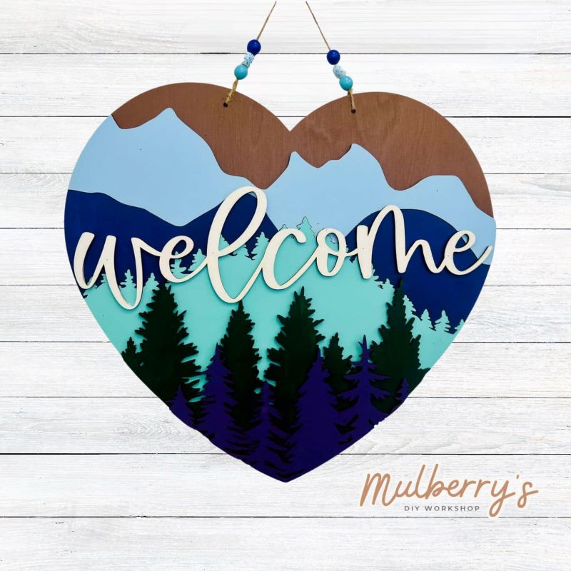 This 18-inch multilayered heart door hanger makes a huge statement featuring the beautiful Blue Ridge Mountains and the word "welcome".