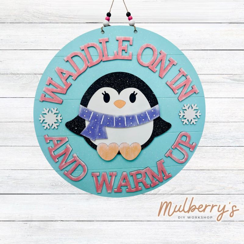 Waddle on in and warm up! Our winter penguin 22" door hanger is perfect for your front door or school classroom door!