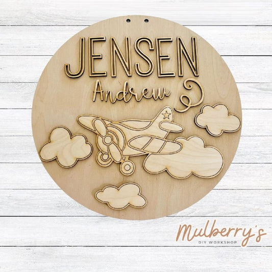 Celebrate the birth of your little one with our 18" personalized airplane nursery door hanger!