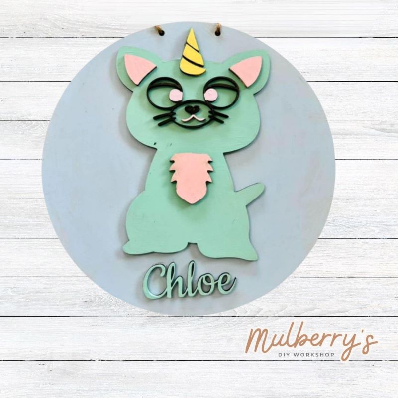 Our mini 9.5" door hanger with a caticorn and is a popular project for kids! This design can be personalized with a name in either print or cursive.