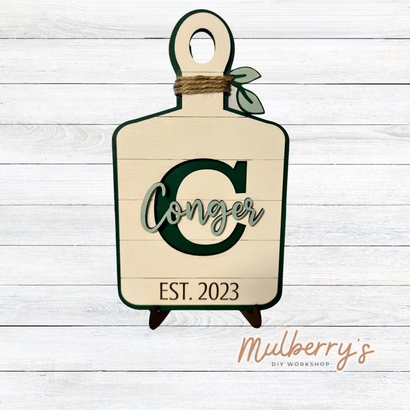 Display your last name and established date with our personalized last name cutting board! Approximately 12" tall by 6.5" wide. Optional stand is available.