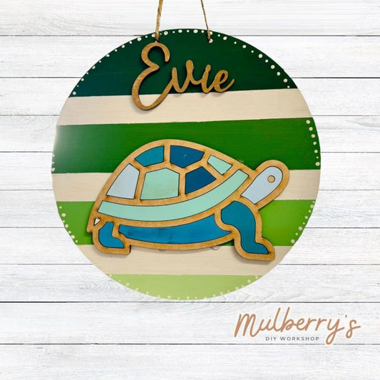 Our mini 9.5" door hanger with a turtle and is a popular project for kids! This design can be personalized with a name in either print or cursive.