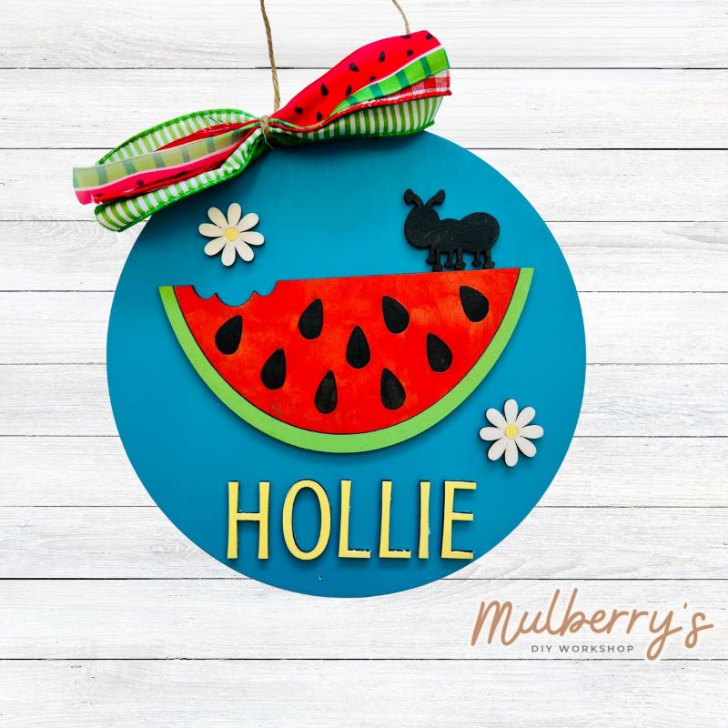 Our mini 9.5" door hanger with a watermelon is a popular project for kids! This design can be personalized with a name in either print or cursive.