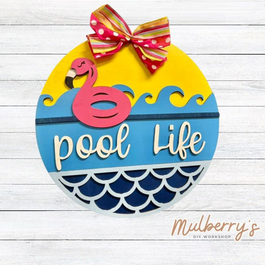 Our pool life 18" door hanger is perfect for louging around by the pool! Can be customized to say "Beach Life" as well.