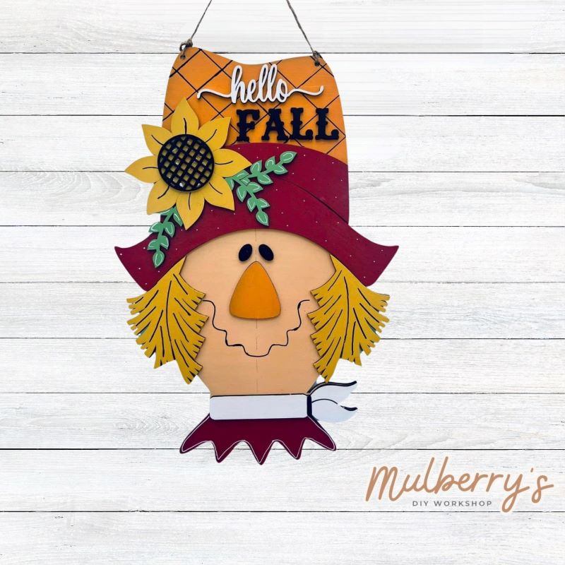 Our hello fall scarecrow mini door hanger is so cute! Approximately 15" tall by 10.5" wide.