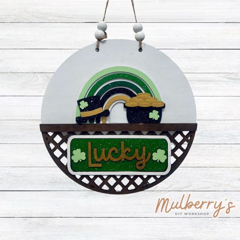 Welcome family and friends with our interchangeable lattice round door hanger! Simply swap out inserts to match the different holidays and seasons!

It's approximately 10.5" in diameter.

Includes: Lattice Round Door Hanger with St. Patty rainbow Inserts. Additional inserts are available to purchase.