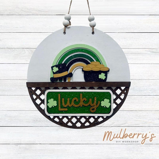 Welcome family and friends with our interchangeable lattice round door hanger! Simply swap out inserts to match the different holidays and seasons!

It's approximately 10.5" in diameter.

Includes: Lattice Round Door Hanger with St. Patty rainbow Inserts. Additional inserts are available to purchase.