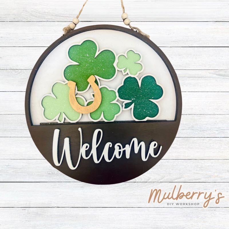 Welcome family and friends with our interchangeable welcome door hanger! Simply swap out inserts to match the different holidays and seasons! It's approximately 10.5" in diameter.  Includes: Welcome Door Hanger with Shamrock Insert. Additional inserts are available to purchase.