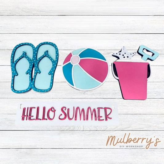 Our summer inserts are so versatile! Display them individually or in our interchangeable wagon or crate! Includes flip flops, beach ball, sand bucket, and the Hello Summer banner.