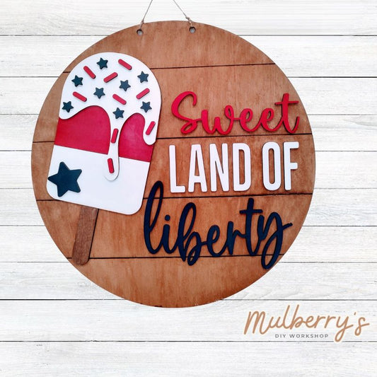 Make a statement this 4th of July with our Sweet Land of Liberty 22" door hanger!