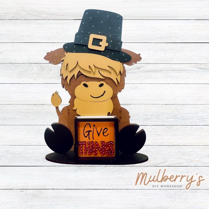 We love our interchangeable highland cow! It's approximately 9" tall and can be paired with your favorite seasonal/holiday insert. This set includes the interchangeable highland cow and the thanksgiving inserts.