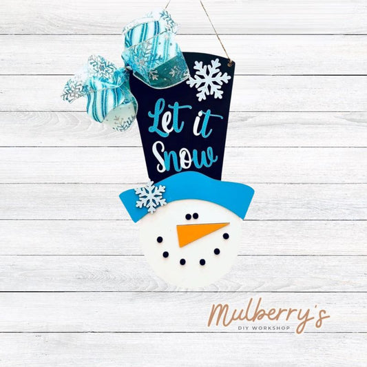 Bring the joys of winter to any room with this top hat "Let It Snow" snowman. This mini door hanger is approximately 16" tall by 7" wide.
