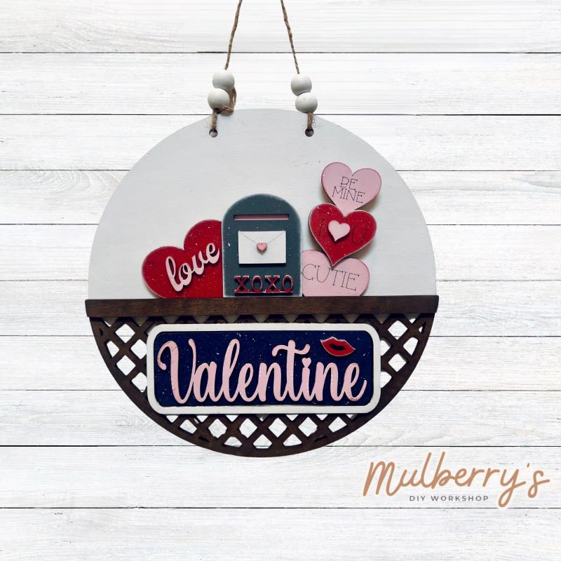 Welcome family and friends with our interchangeable lattice round door hanger! Simply swap out inserts to match the different holidays and seasons! It's approximately 10.5" in diameter.  Includes: Lattice Round Door Hanger with Valentine Inserts. Additional inserts are available to purchase.