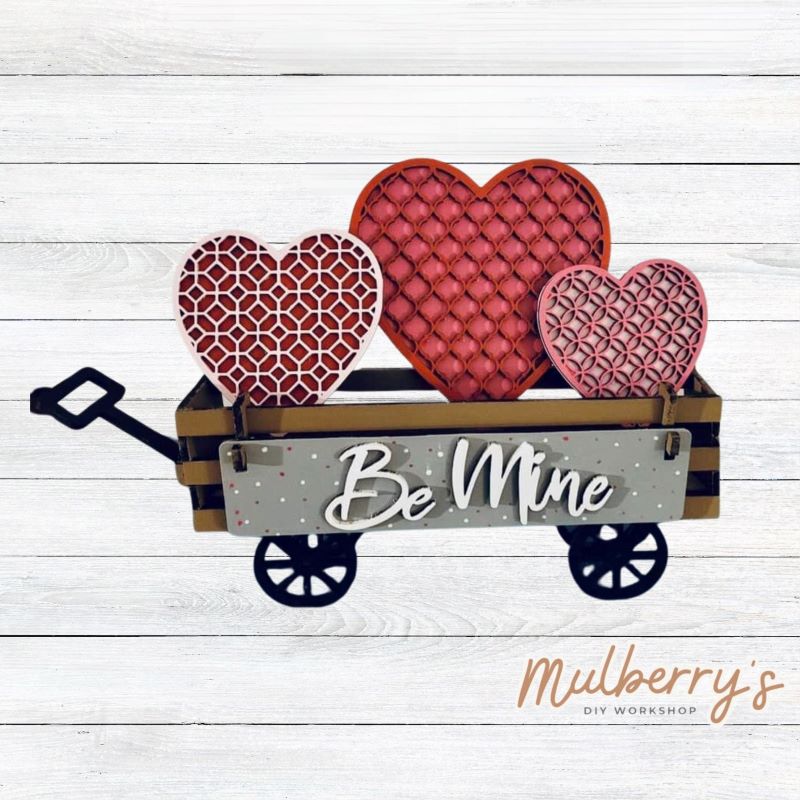 It doesn't get any cuter than our little rustic wagon! It's a perfect add on accessory to your décor. It's approximately 4" tall. Includes: Wagon and Valentine Inserts. Valentine inserts include three hearts and the Be Mine banner.