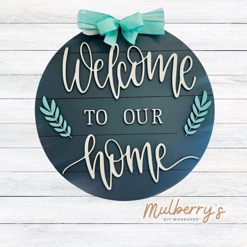 Decorate your front door with our 22" Welcome To Our Home door hanger!