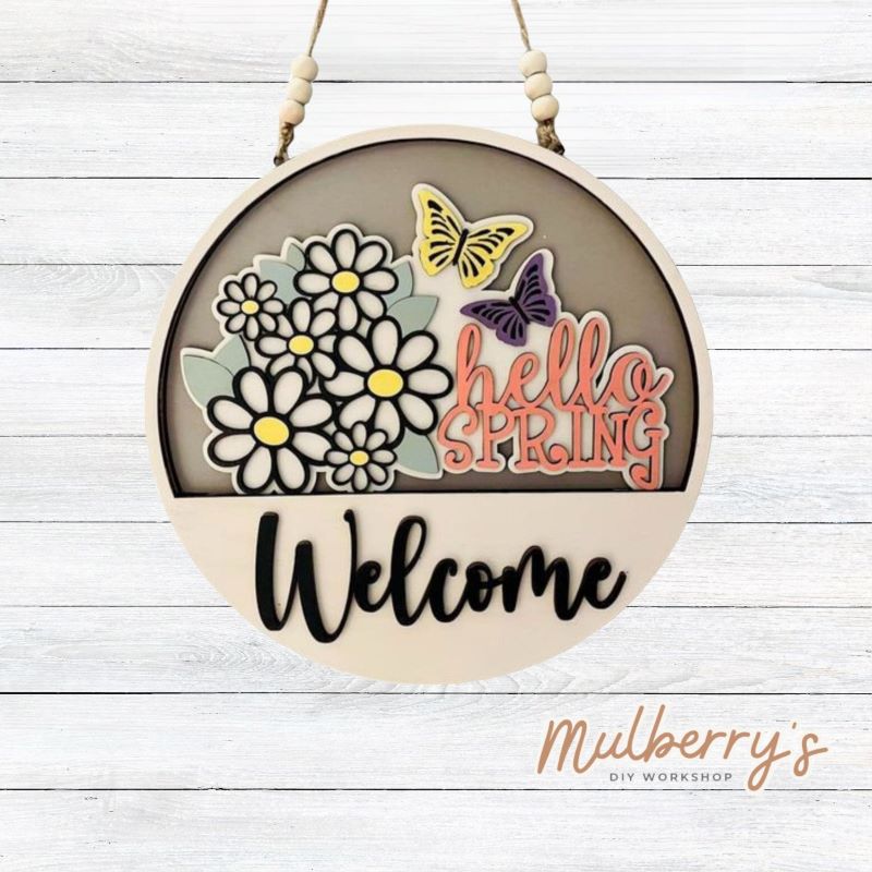Welcome family and friends with our interchangeable welcome door hanger! Simply swap out inserts to match the different holidays and seasons! It's approximately 10.5" in diameter.  Includes: Welcome Door Hanger with Hello Spring Insert. Additional inserts are available to purchase.