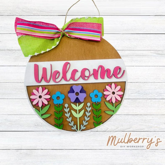 Our Welcome Flowers mini door hanger is the perfect hanger to welcome your family and friends this spring! Approximately 10" in diameter.