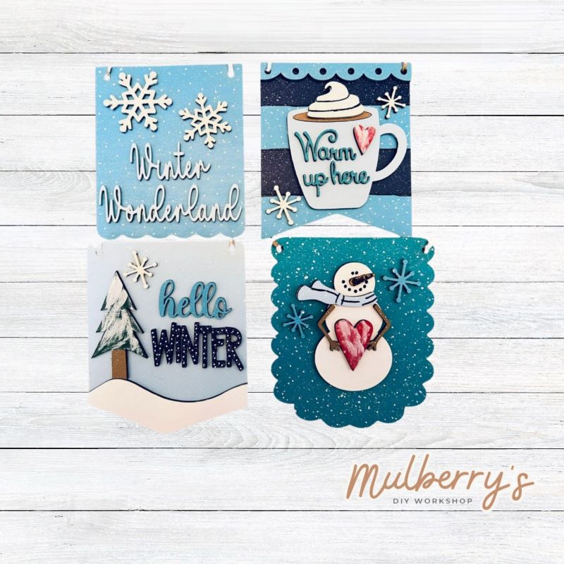 Our winter banner ornaments are too cute! Each are approximately 5" tall by 5" wide.